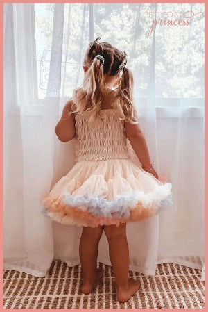 soft champagne tutu dress with pastel rainbow ruffles