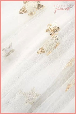 close up of white and sequin star tulle dress